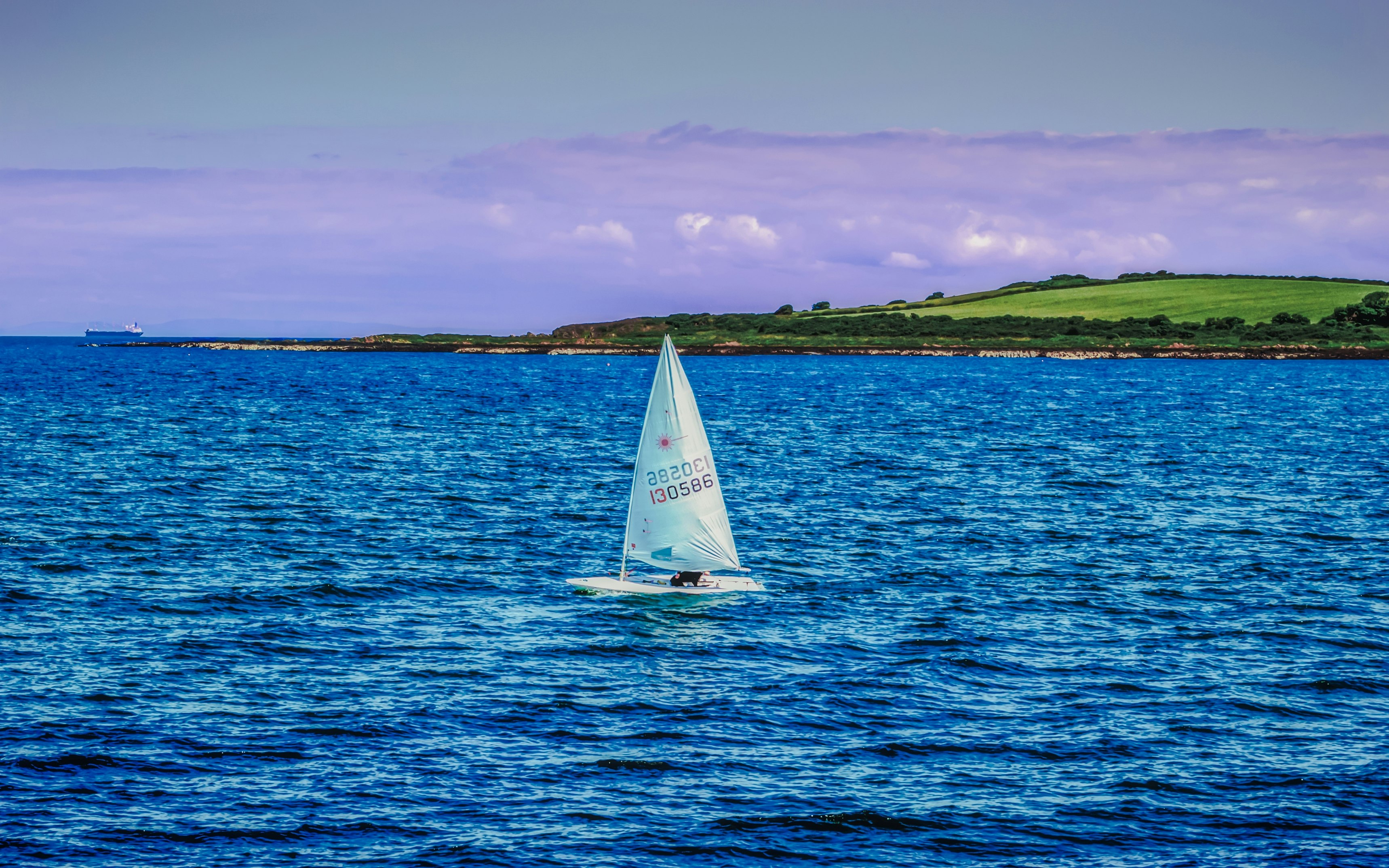 white sailboat on sea under blue sky during daytime